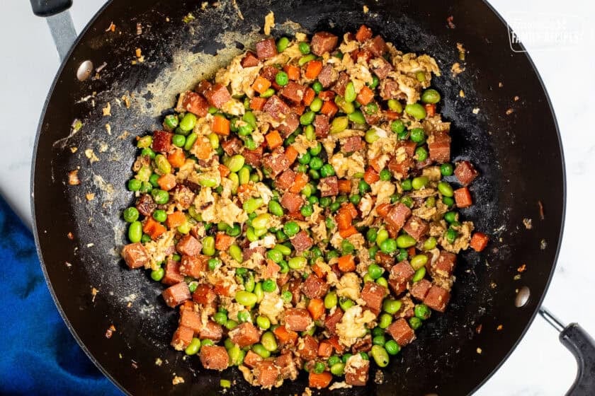 Wok with cooked vegetables, spam and scrambled eggs.