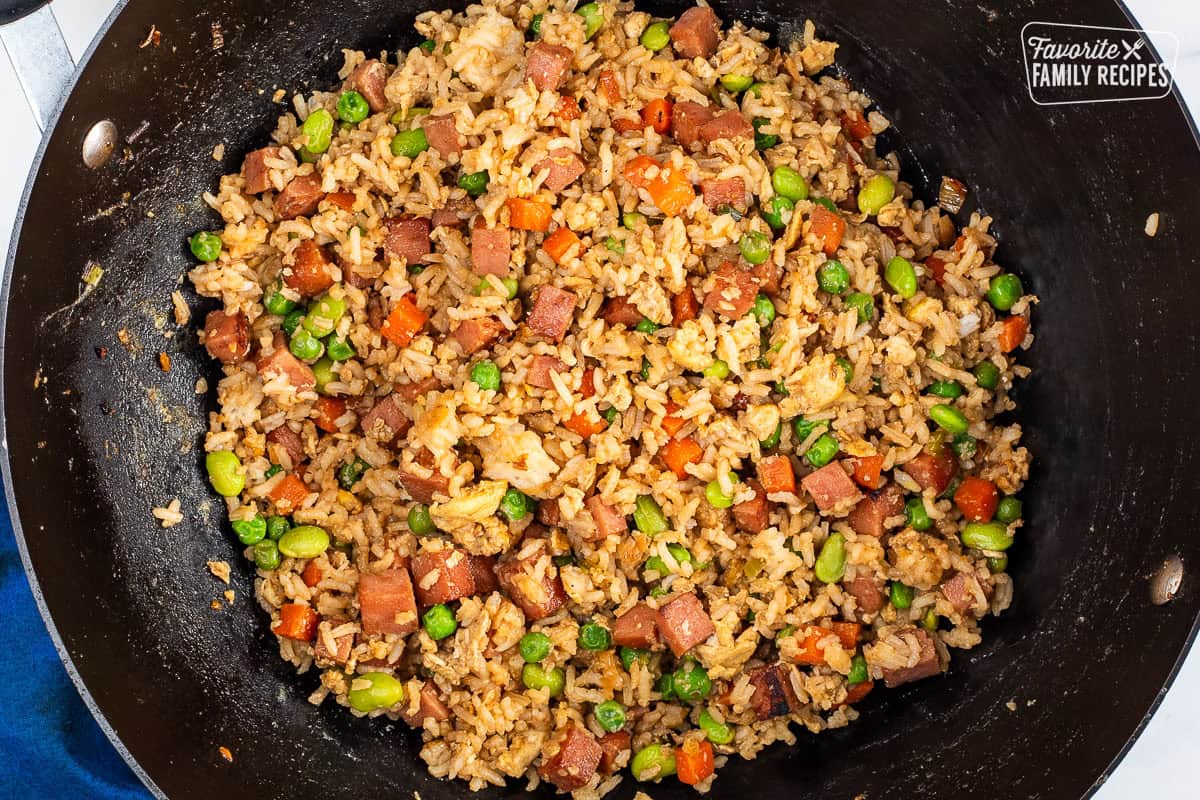 Wok of spam fried rice with spam, carrots, peas, soy beans and scrambled eggs.