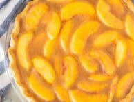 Fresh Peach Pie in a pie plate glass dish.