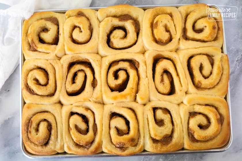 Baked Biscoff cinnamon rolls on a cookie sheet.