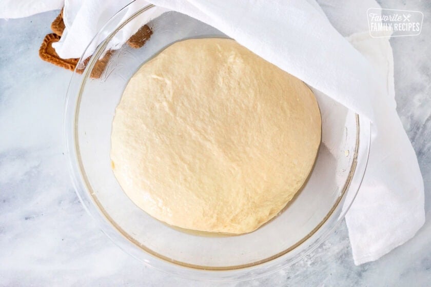 Oil bowl with dough ball and linen for covering.