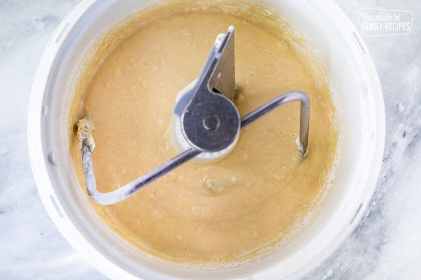 Mixing bowl with dough hook attachment with milk, some flour, melted butter and salt.