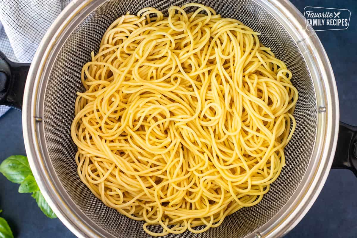 Cooked spaghetti in a colander.