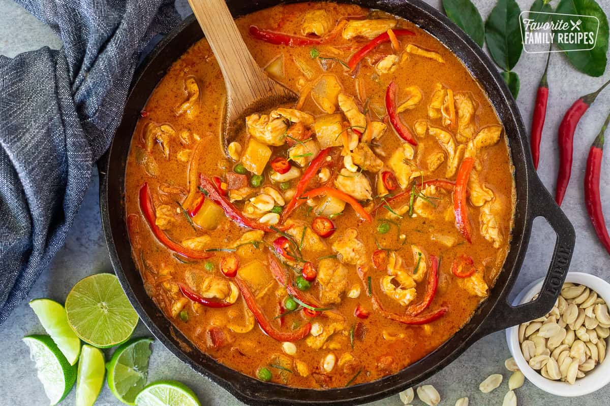 Chicken Panang curry with red bell peppers, peas, potatoes, tomatoes, peas and carrots.