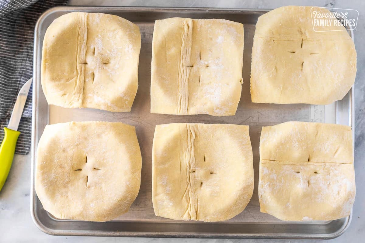 Puff pastry squares on top of ramekins filled with beef pot pie.