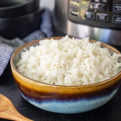 Bowl on instant pot rice next to the instant pot.