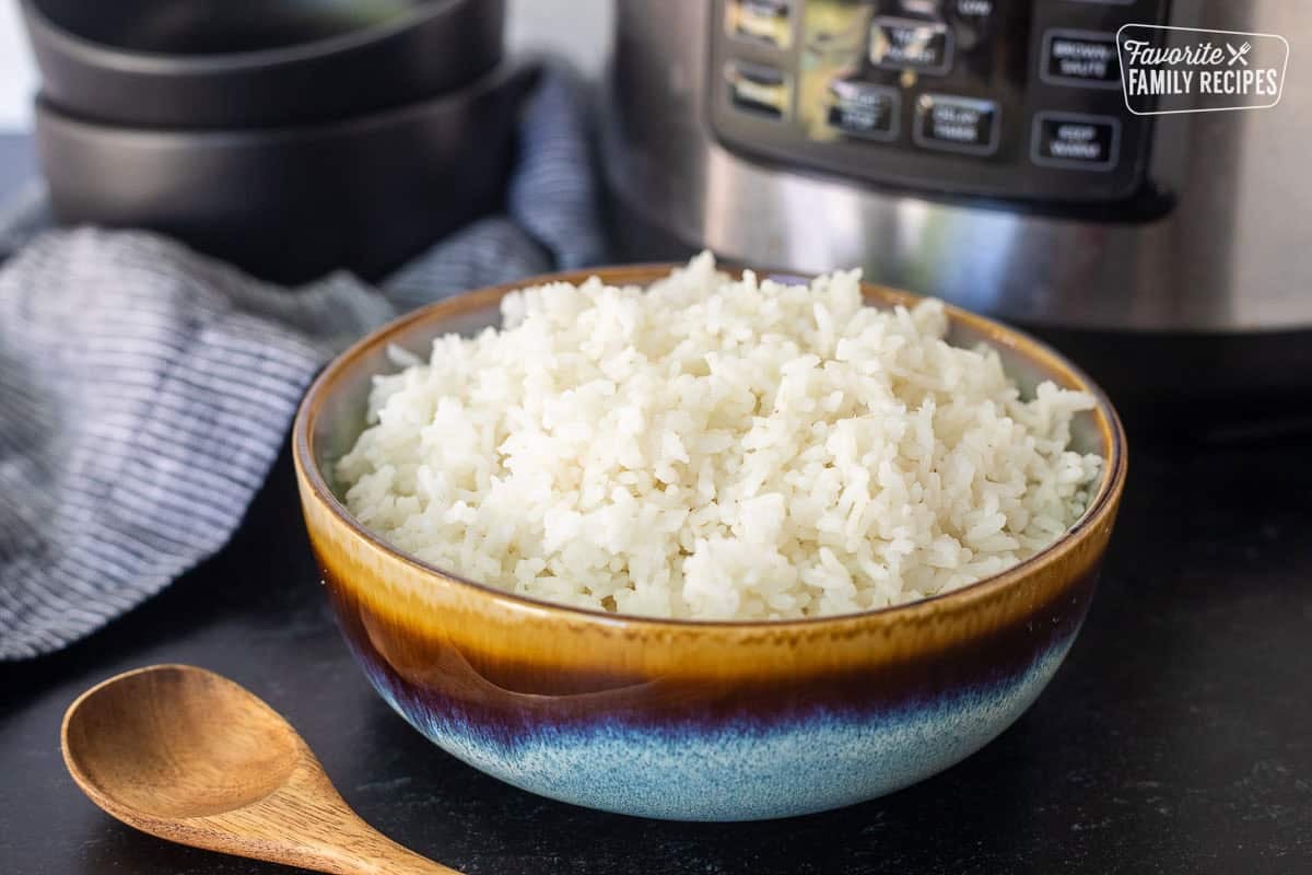 Bowl on instant pot rice next to the instant pot.
