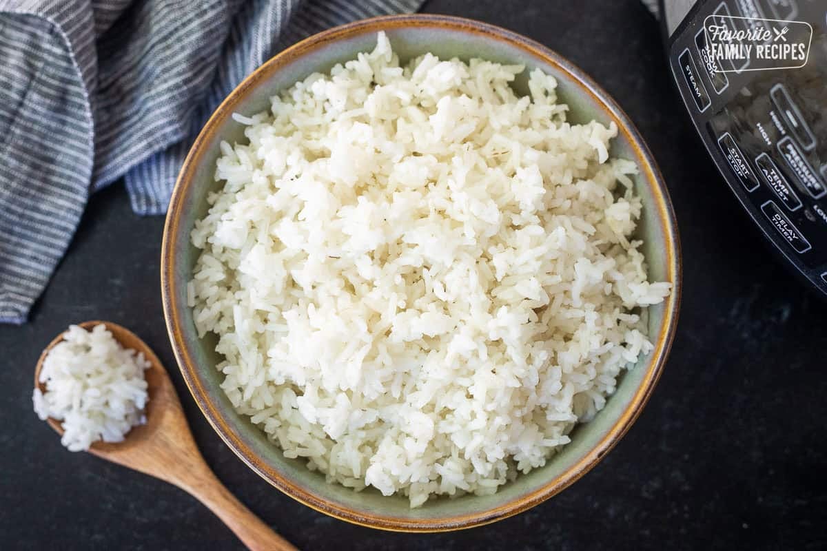 Bowl on instant pot rice next to the instant pot.