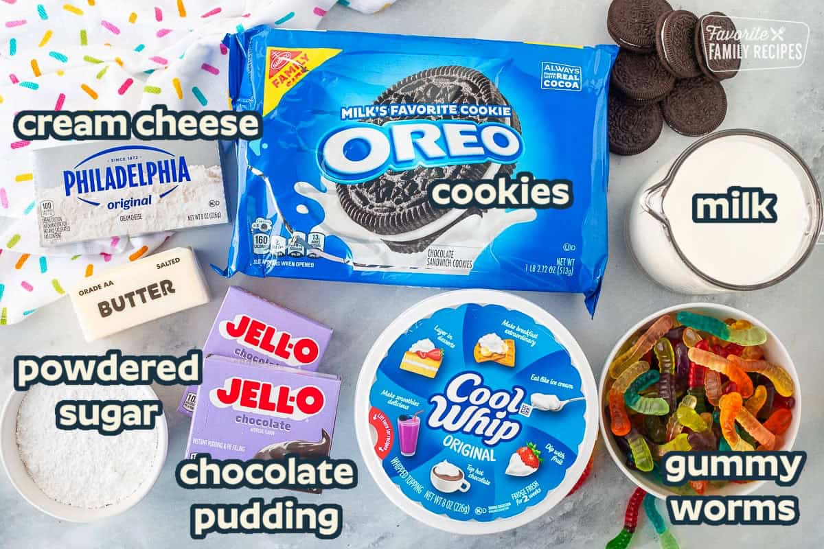 Ingredients to make Dirt Cake including Oreos, milk, gummy worms, Cool Whip, Jello chocolate pudding mixes, powdered sugar, butter and cream cheese.