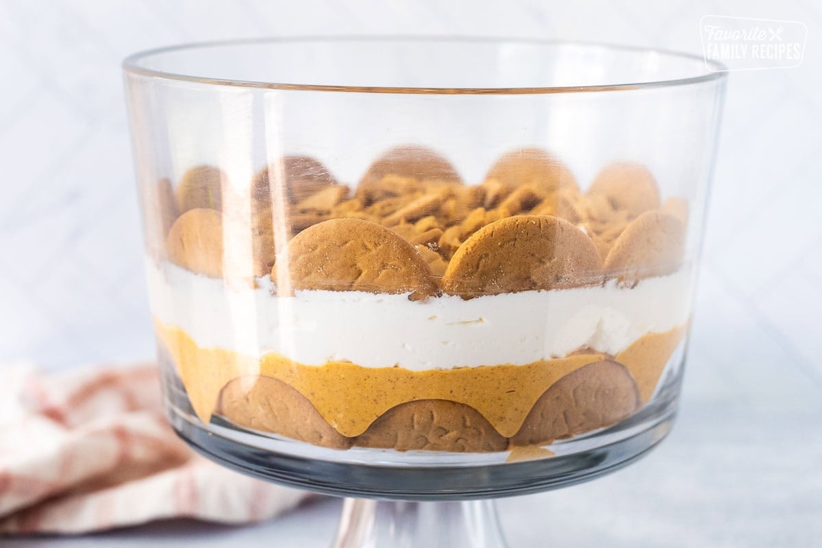 Ginger snap layer over whipped cream layers in the trifle dish.