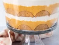 Pumpkin trifle layered with ginger snap cookies, pumpkin cream cheese layer and whipped cream.