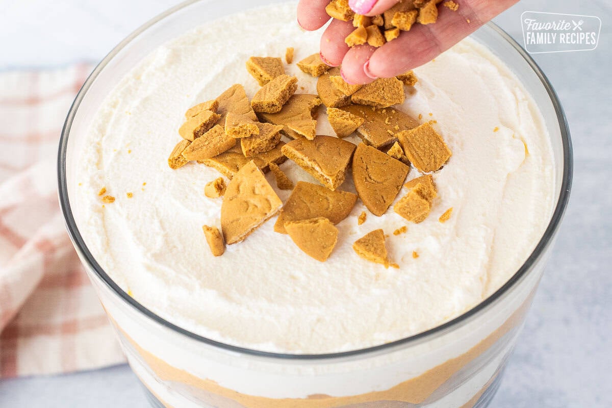 Sprinkling pumpkin trifle with chopped ginger snap cookies.