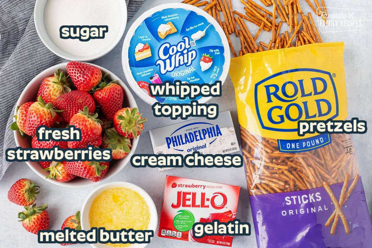 Ingredients to make Strawberry Pretzel Salad including strawberries, cool whip, sugar, pretzels, cream cheese, strawberry jello and melted butter.