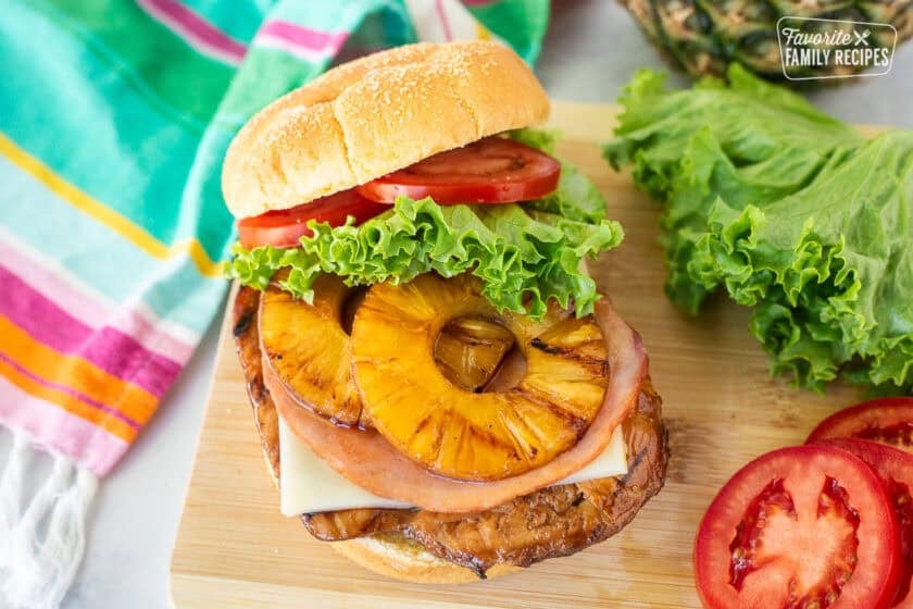 Grilled Teriyaki Chicken Sandwich with teriyaki chicken, pepper jack cheese, ham, grilled pineapple, lettuce an tomato.