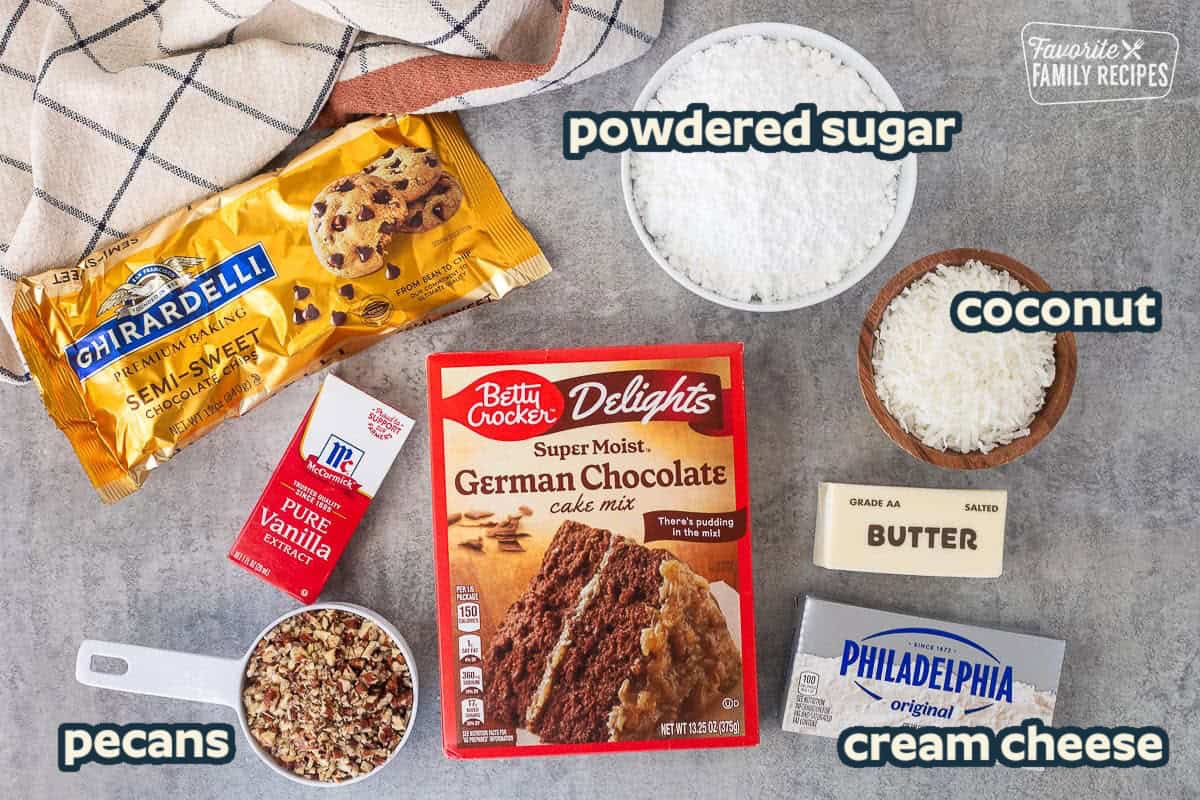 Ingredients needed to make German Chocolate Upside Down Cake: Cake Mix, Coconut, Pecans, Chocolate Chips, Cream Cheese, Powdered Sugar, and Vanilla