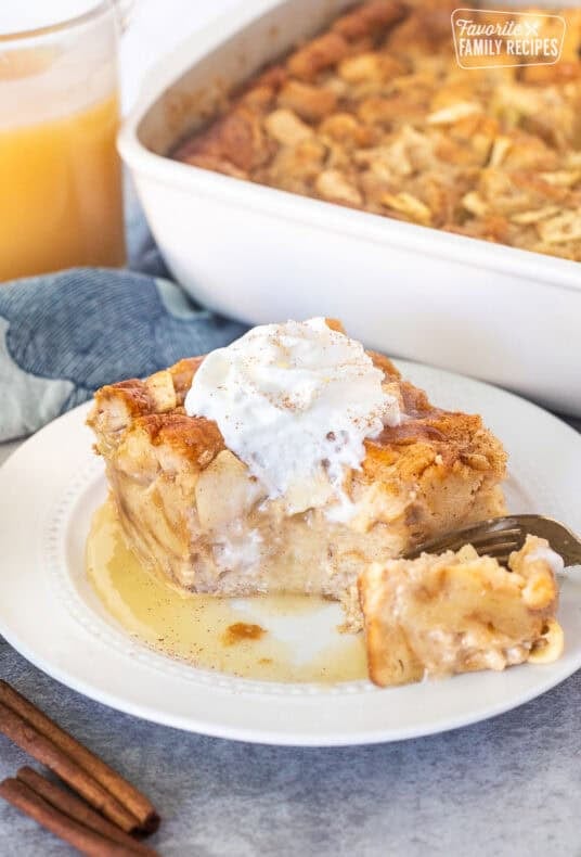 Cut corner of a slice of Apple Bread Pudding with caramel sauce and whipped cream.