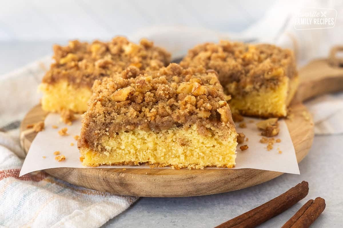 This cake mix coffee cake is so easy and yummy! You are going to love this moist cake with a buttery cinnamon and sugar crumb topping. Three slices of Cake mix coffee cake on a board.
