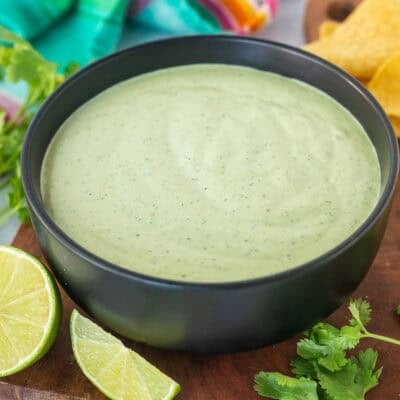 Bowl of Cilantro Lime Sauce next to tortilla chips.