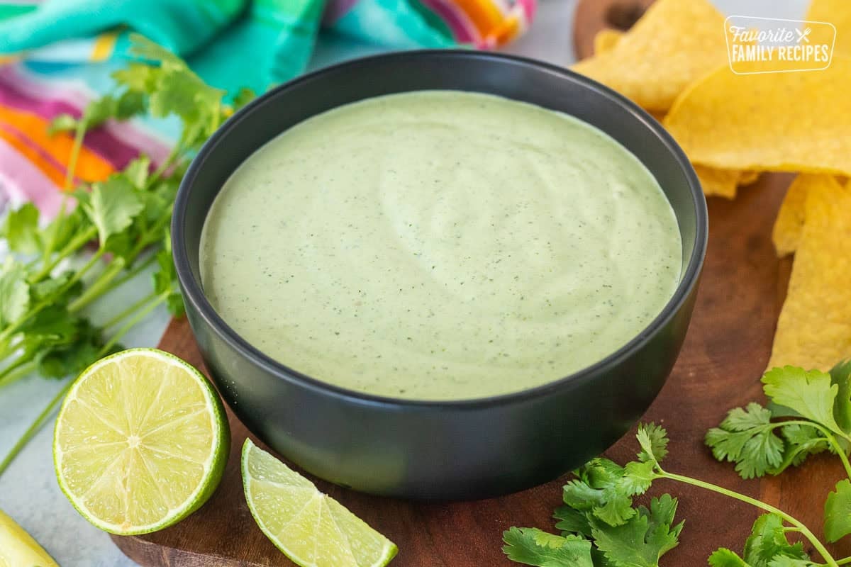 Bowl of Cilantro Lime Sauce next to tortilla chips.