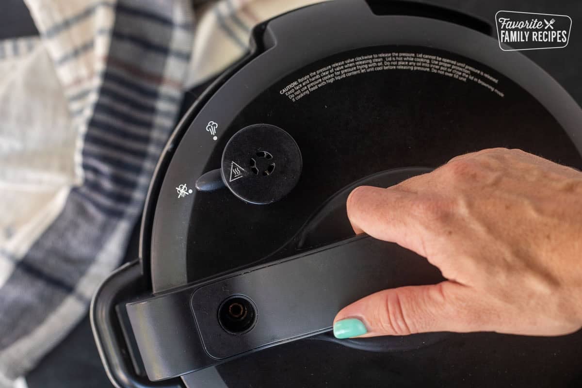 Sealing lid of instant pot by hand.