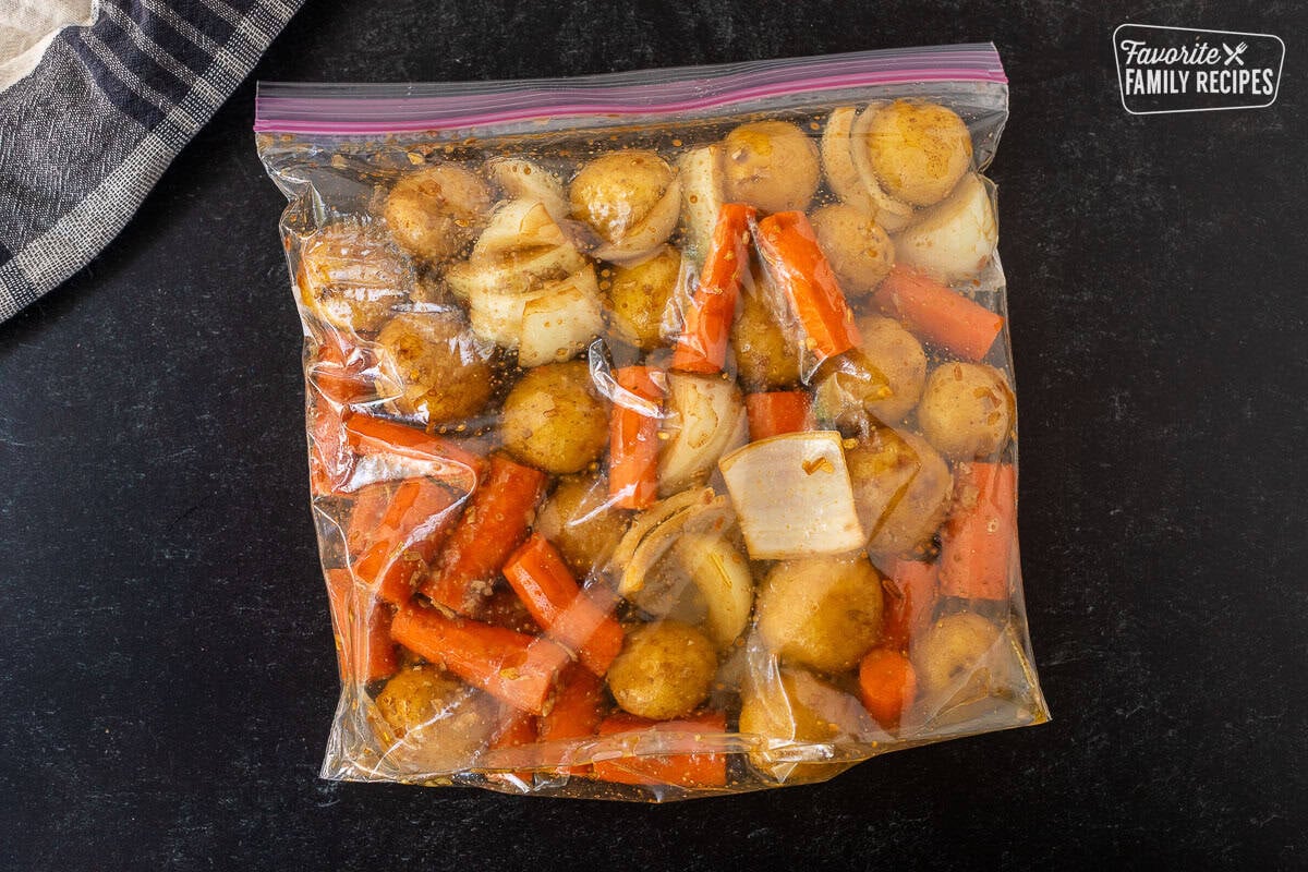 Ziploc bag with carrots, baby potatoes, onion and Lipton soup mix.