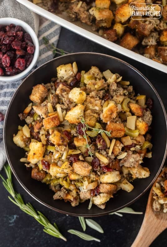 Bowl of Sausage Stuffing garnished with thyme.