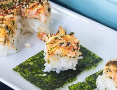 Pieces of sushi bake on top of nori.