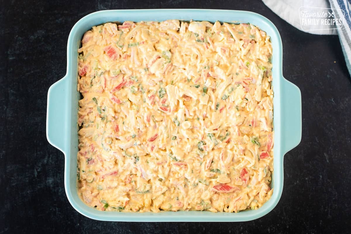 Crab layer on top of sushi rice in 8x8 dish.