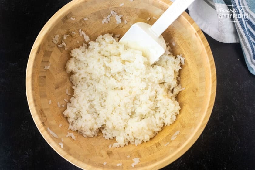 Bowl of cooked sushi rice mixed with rice vinegar and sugar for sushi bake.