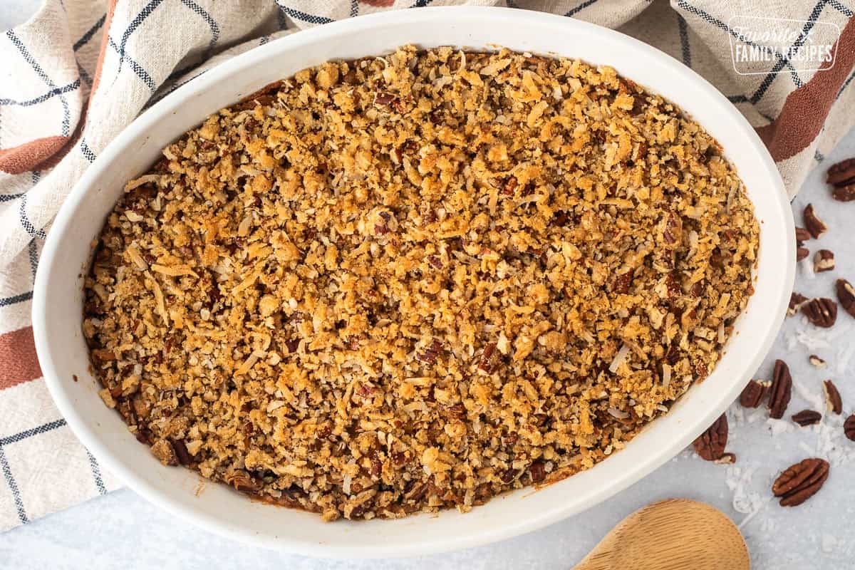 Baked sweet potato casserole with pecan topping in a baking dish.