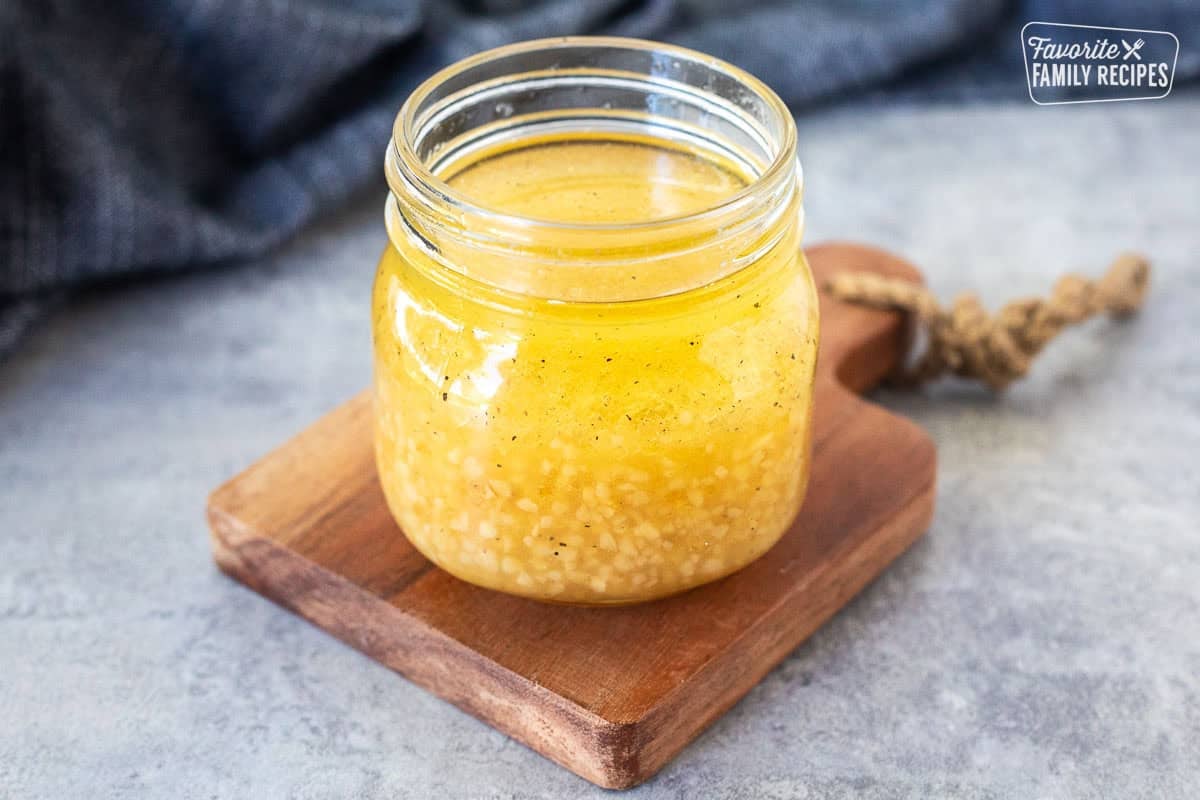 Chicken thigh marinade in glass jar.