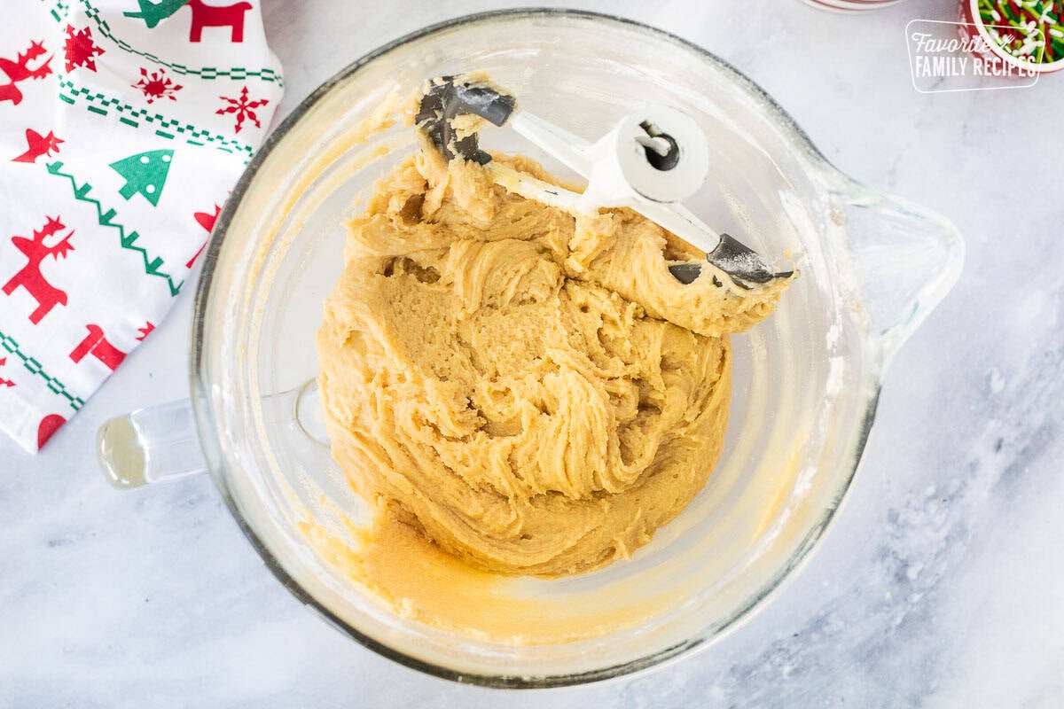 Glass mixing bowl with cookie dough and paddle attachment.