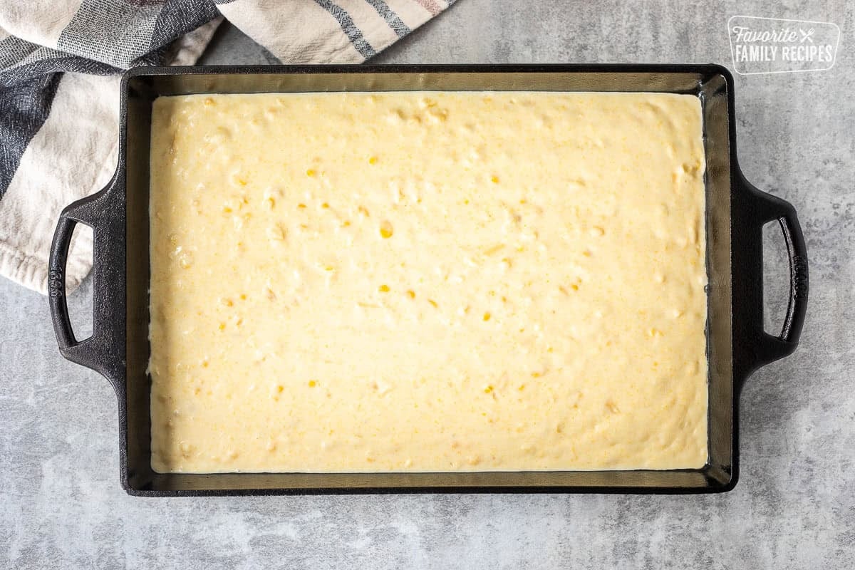 Baking dish with unbaked cornbread pudding.