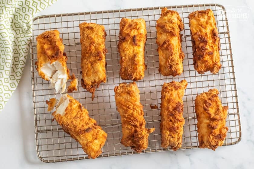 Fried pieces of Halibut on a cooling rack.