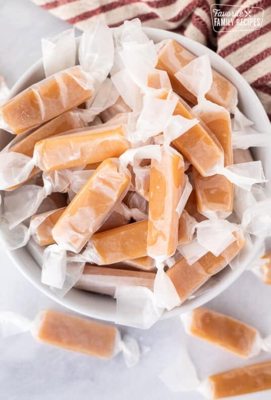 Bowl of Mom's homemade caramels wrapped in wax paper.