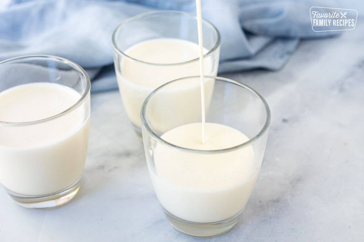 Pouring panna cotta into glasses.