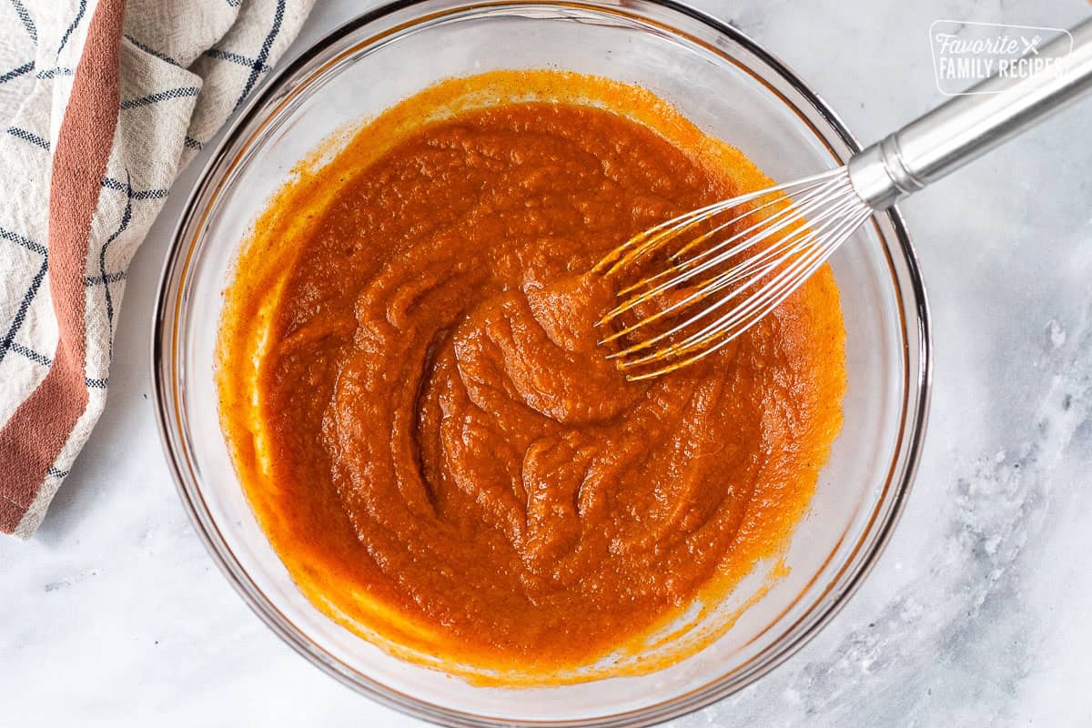 Stirring pumpkin into pumpkin pie filling mixture to make a classic pumpkin pie