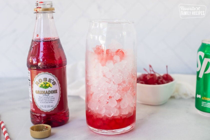 Cup of pebble ice with Grenadine syrup at the bottom.