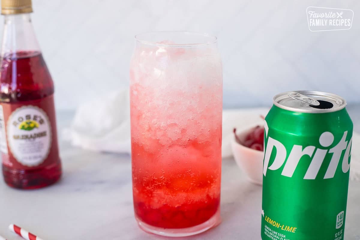 Tall glass of Shirley Temple Drink with pebble ice, Grenadine syrup and Sprite.