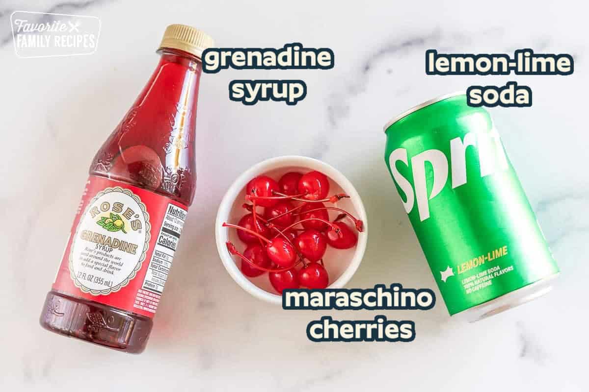 Ingredients to make a Shirley Temple drink: grenadine syrup, lemon-lime soda, and maraschino cherries