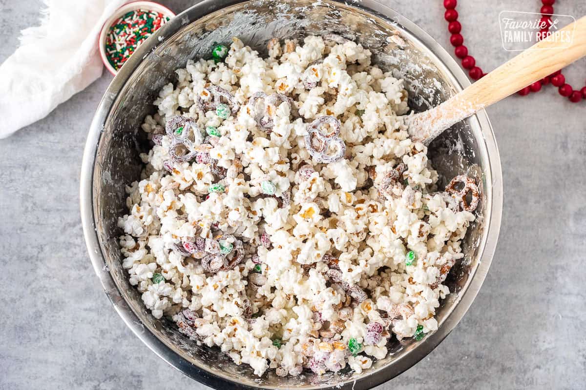Large mixing bowl filled with white chocolate Christmas Popcorn.