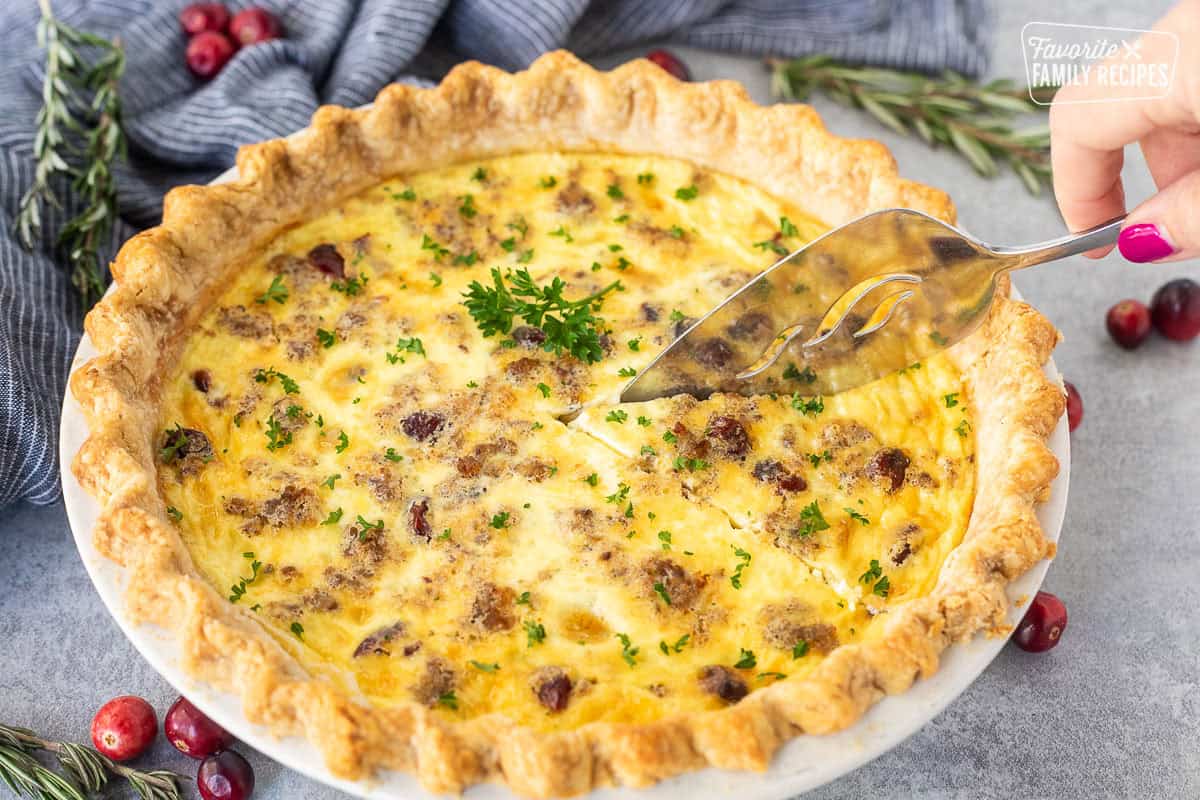 Slicing Christmas Quiche with a spatula.