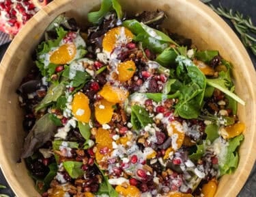 Christmas salad with spring mix, feta, candied pecans, pomegranate, mandarin oranges, dried cranberries and poppyseed dressing.