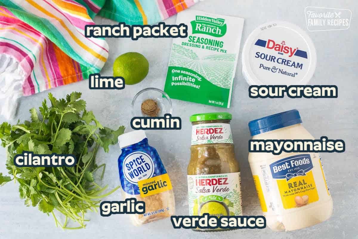 Ingredients to make Cilantro Lime Sauce including sour cream, mayonnaise, Herdez Salsa Verde, Ranch dressing packet, lime, cumin, minced garlic and cilantro.