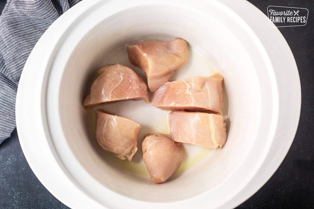 Sliced chicken breast in a crock pot.