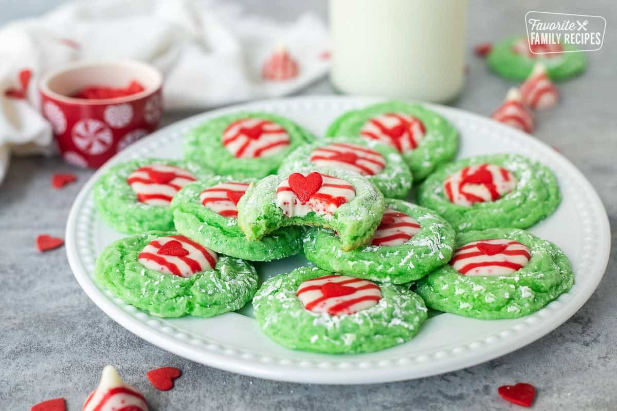 Plate with Grinch cookies with the top cookie missing a bite.