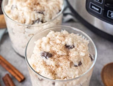 Instant pot roast pudding served in two glasses. Cinnamon sprinkled on top.