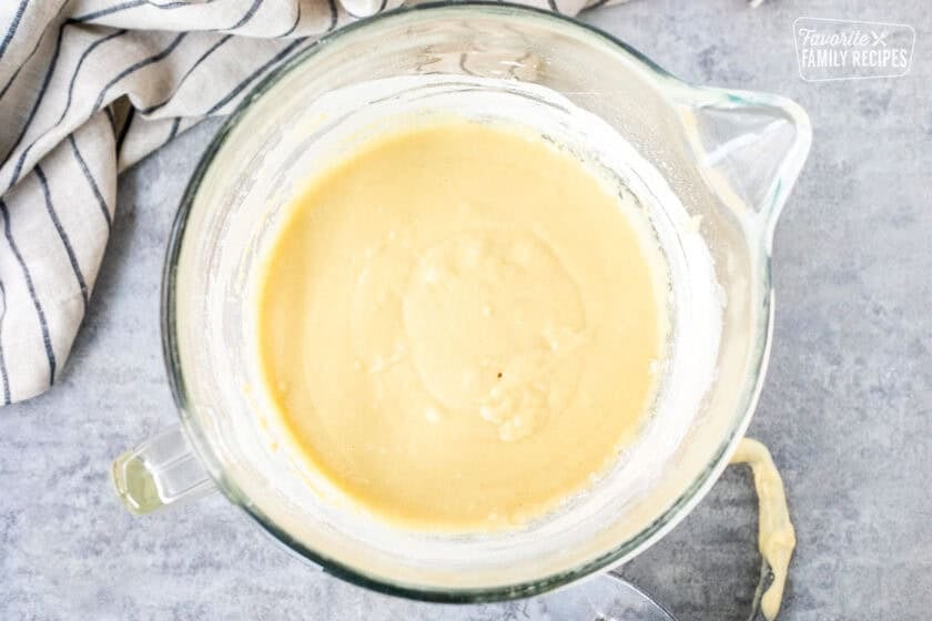 A mixing bowl with yeast, eggs, milk, butter, sugar, and salt combined to make Sally Lunn bread.