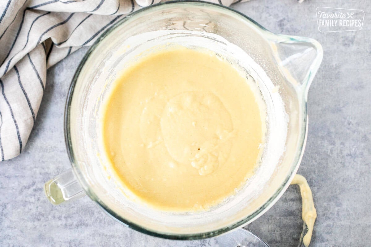 A mixing bowl with yeast, eggs, milk, butter, sugar, and salt combined to make Sally Lunn bread.