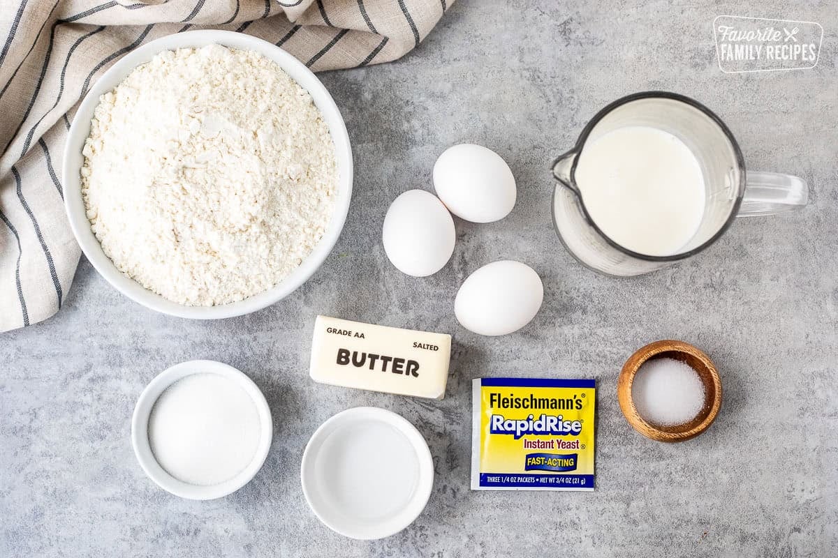 Ingredients to make Sally Lunn Bread including flour, milk, eggs, salt, sugar, milk, water, butter and yeast.
